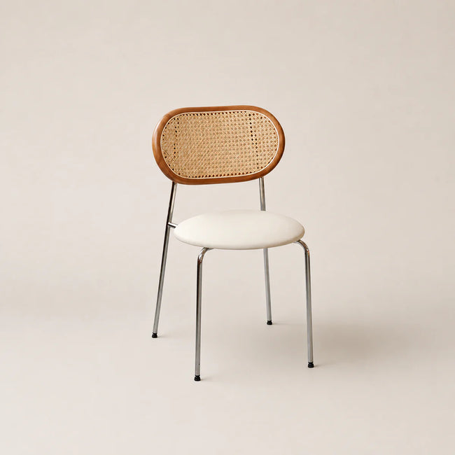 Chair with wicker backrest and white seat on a beige background