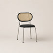 Chair with wicker backrest and black seat on a beige background