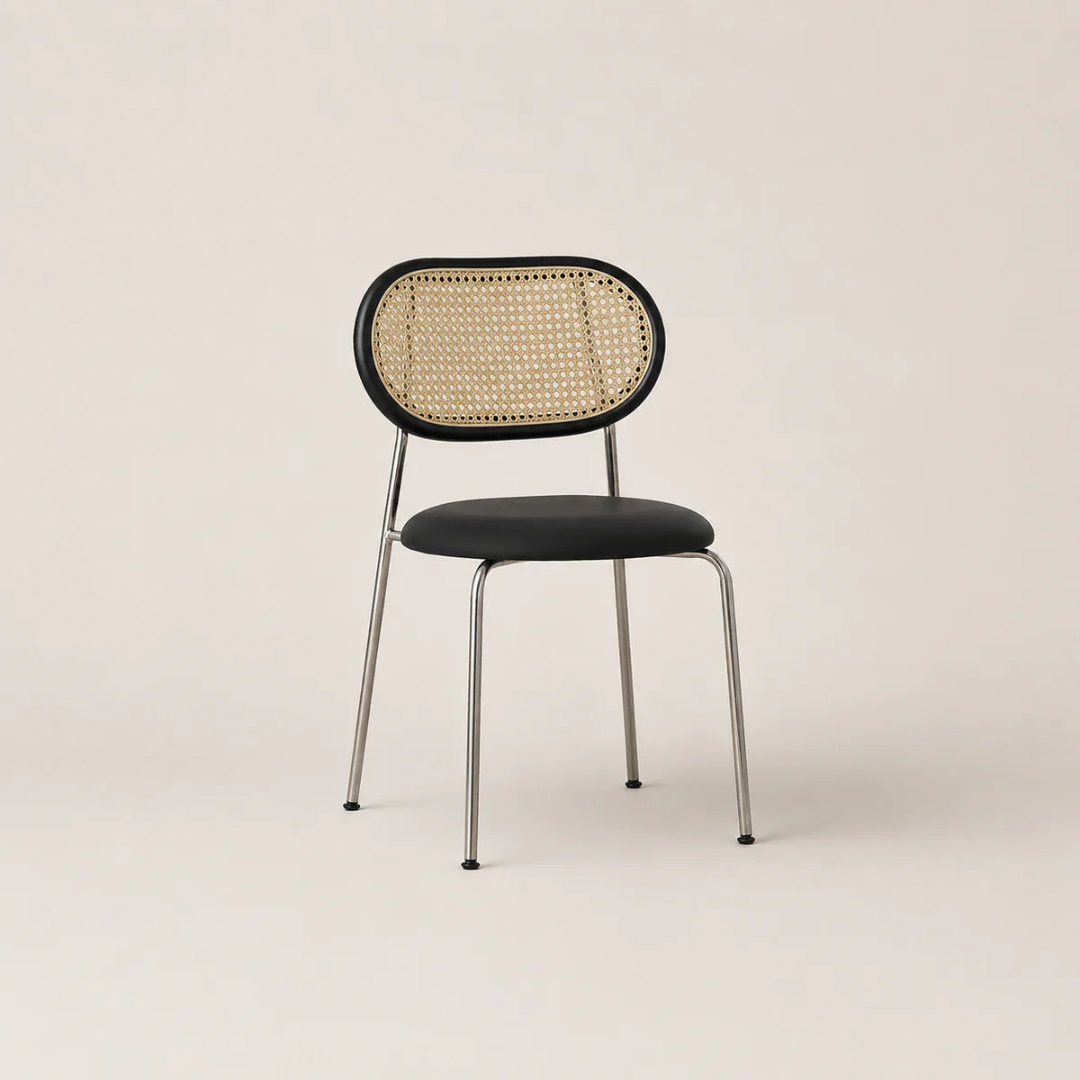 Chair with wicker backrest and black seat on a beige background
