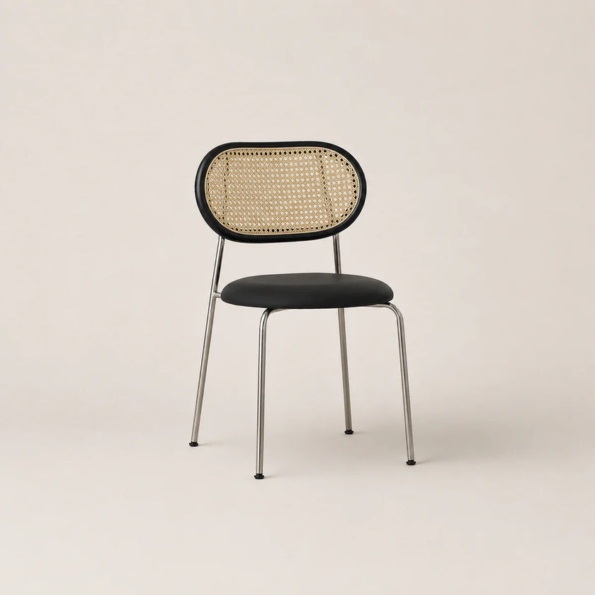 Chair with wicker backrest and black seat on a beige background