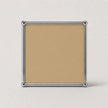 A square tan or beige metal panel print with a polished silver metal border and corner caps, shown against a light gray background.