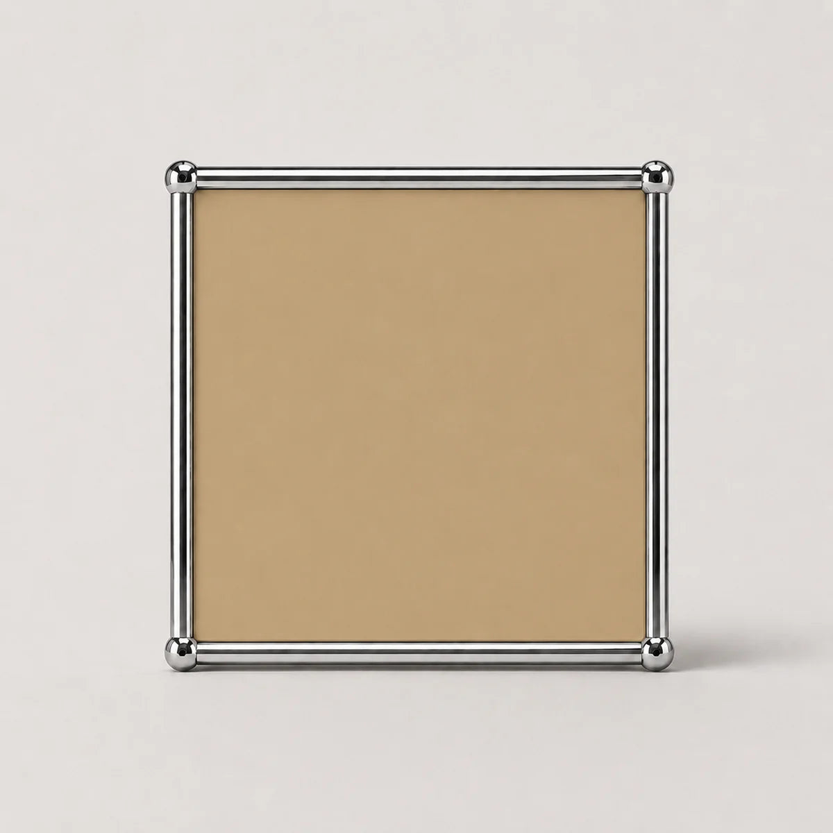 A square tan or beige metal panel print with a polished silver metal border and corner caps, shown against a light gray background.