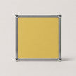A square goose yellow card or insert with a polished silver metal frame, shown against a light gray background.