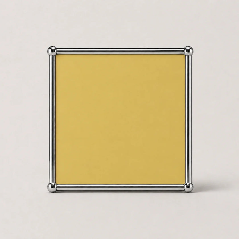 A square goose yellow card or insert with a polished silver metal frame, shown against a light gray background.