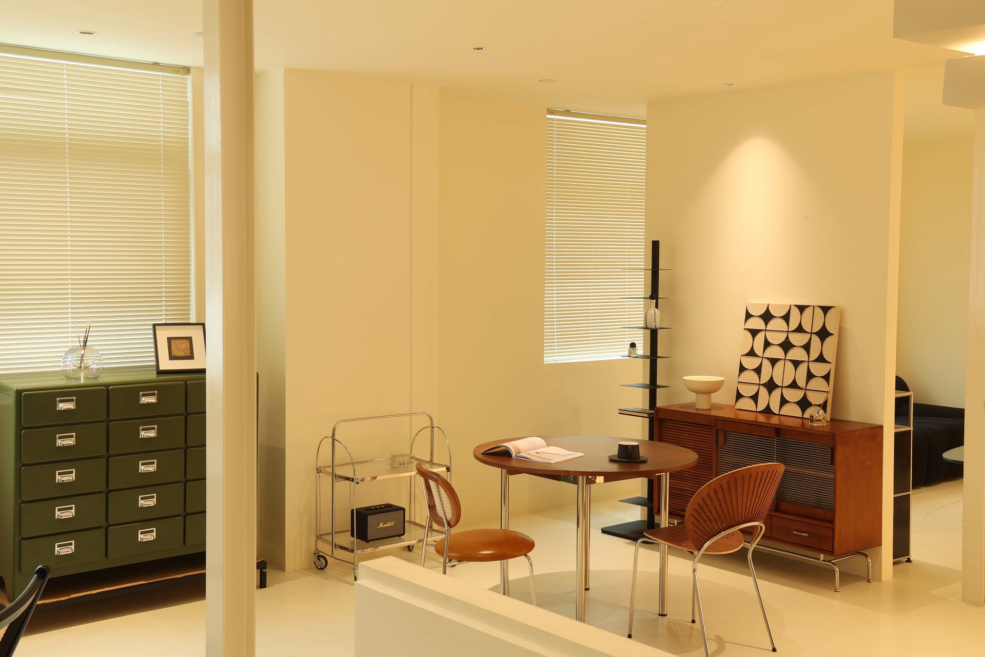 Modern interior design of a room with storage cabinet & utility cart and decor.