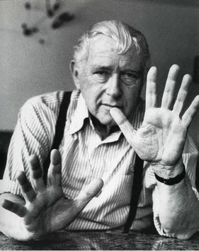 Black and white photo of a man showing his palms with fingers spread