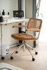 Brown office desk chair with chair cushions & woven backrest in a modern office setting