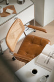 Brown leather office wassily chair with wicker backrest in a home office setting.