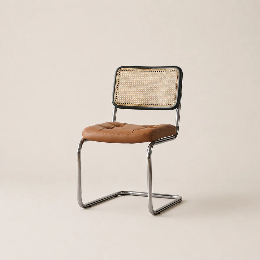 Chair with brown leather seat and wicker back on a beige background