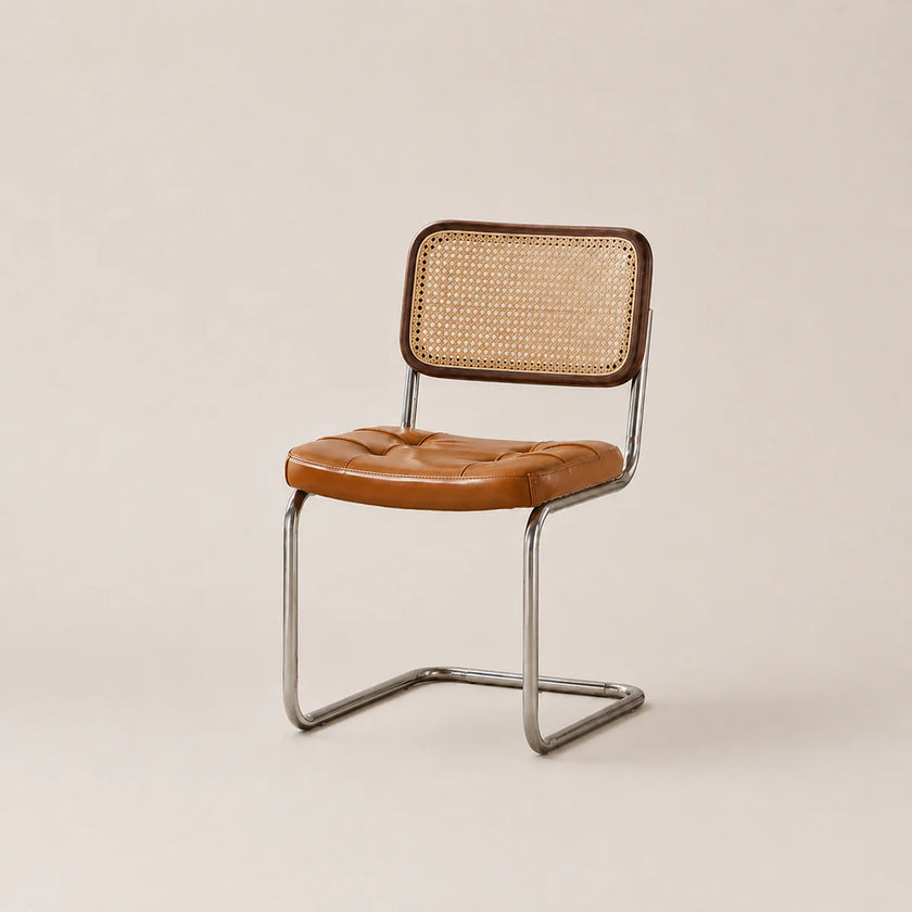 Chair with brown leather seat and wicker back on a beige background