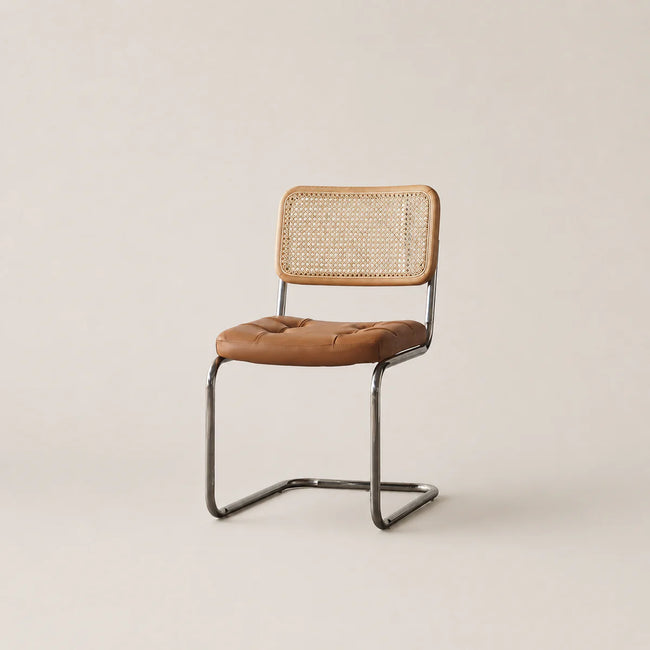 Chair with brown leather seat and woven backrest on a beige background