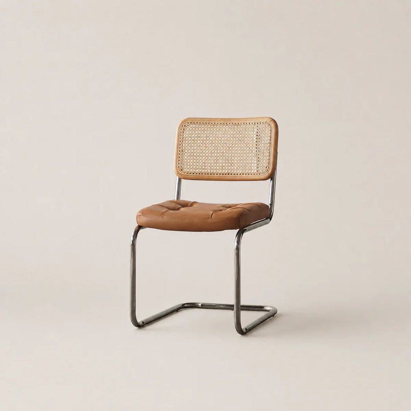 Chair with brown leather seat and woven backrest on a beige background