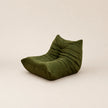 Green bean bag chair on a beige background