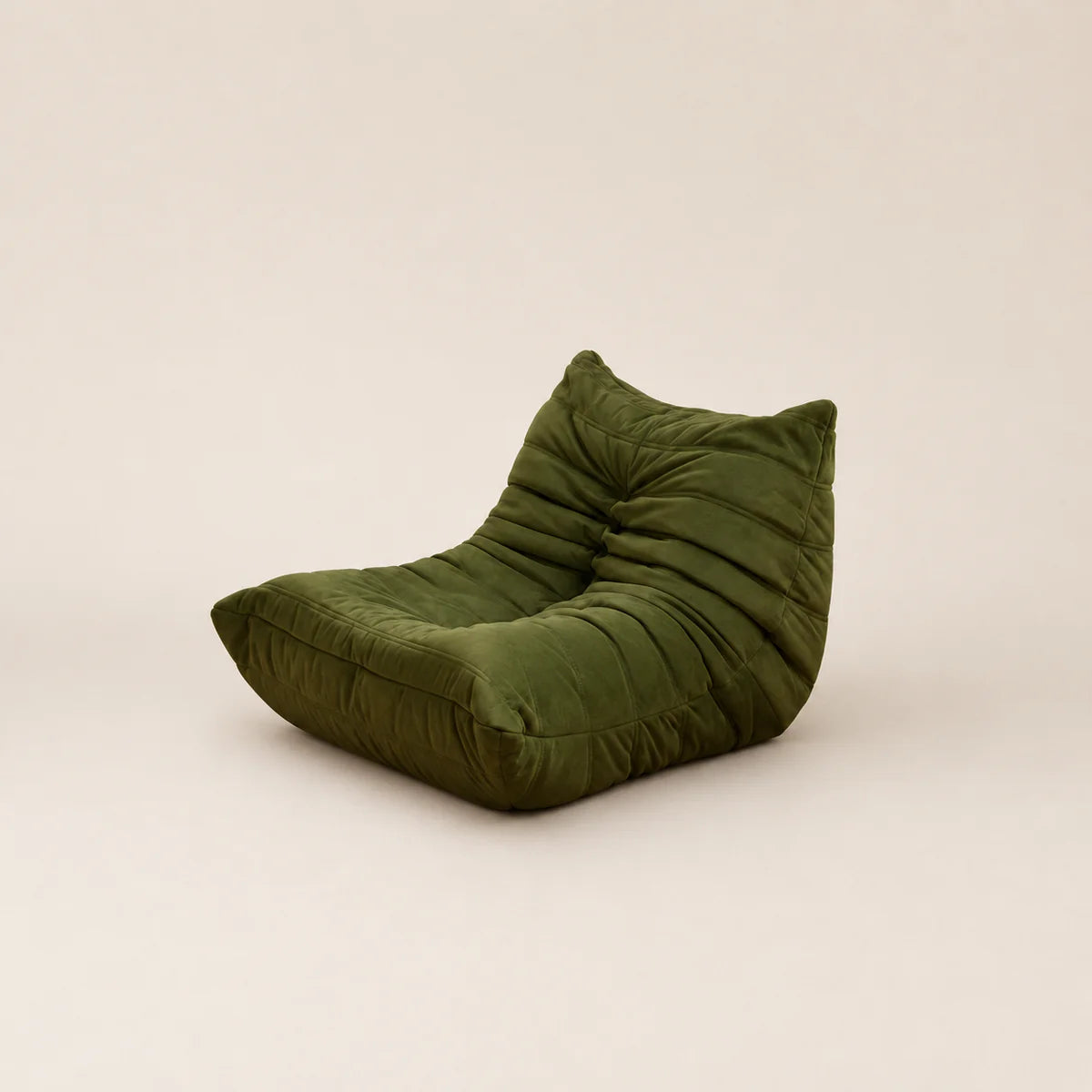 Green bean bag chair on a beige background