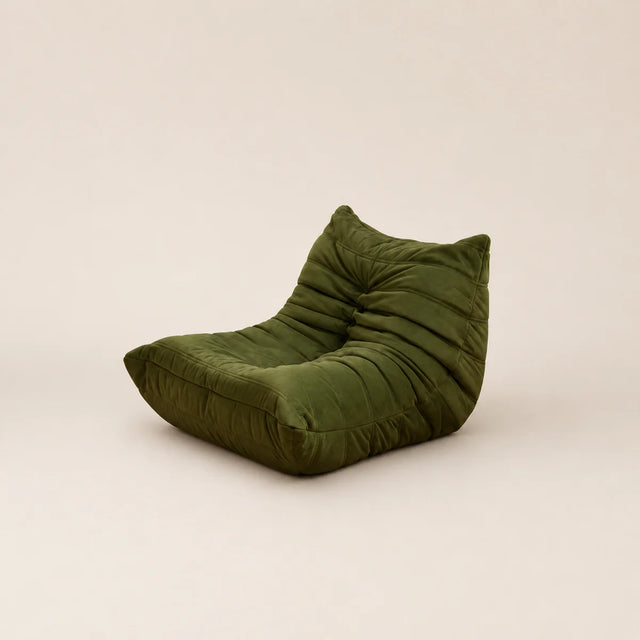 Green bean bag chair on a beige background