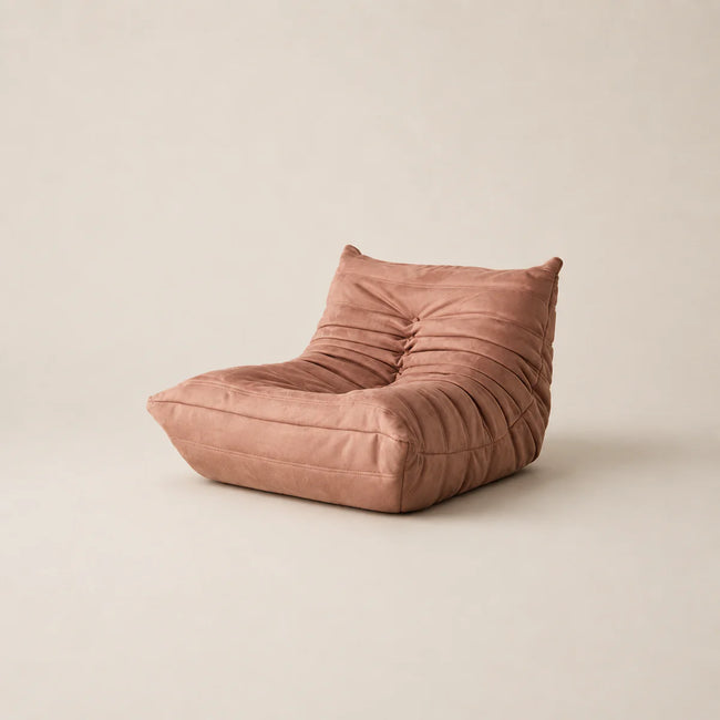 Pink bean bag chair on a beige background