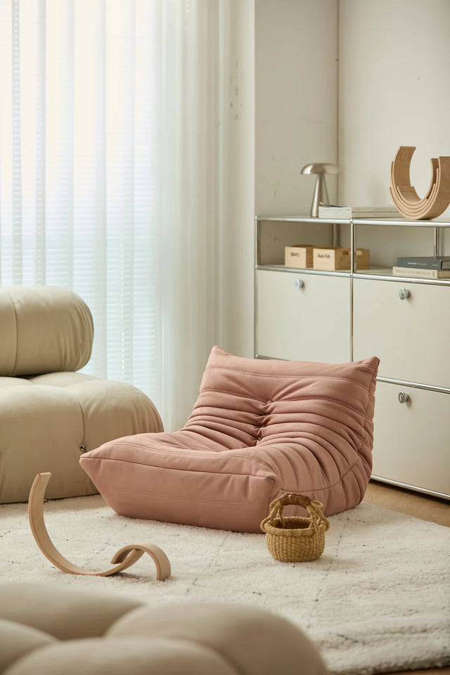 Pink kid corduroy sofa in a modern living room with neutral tones