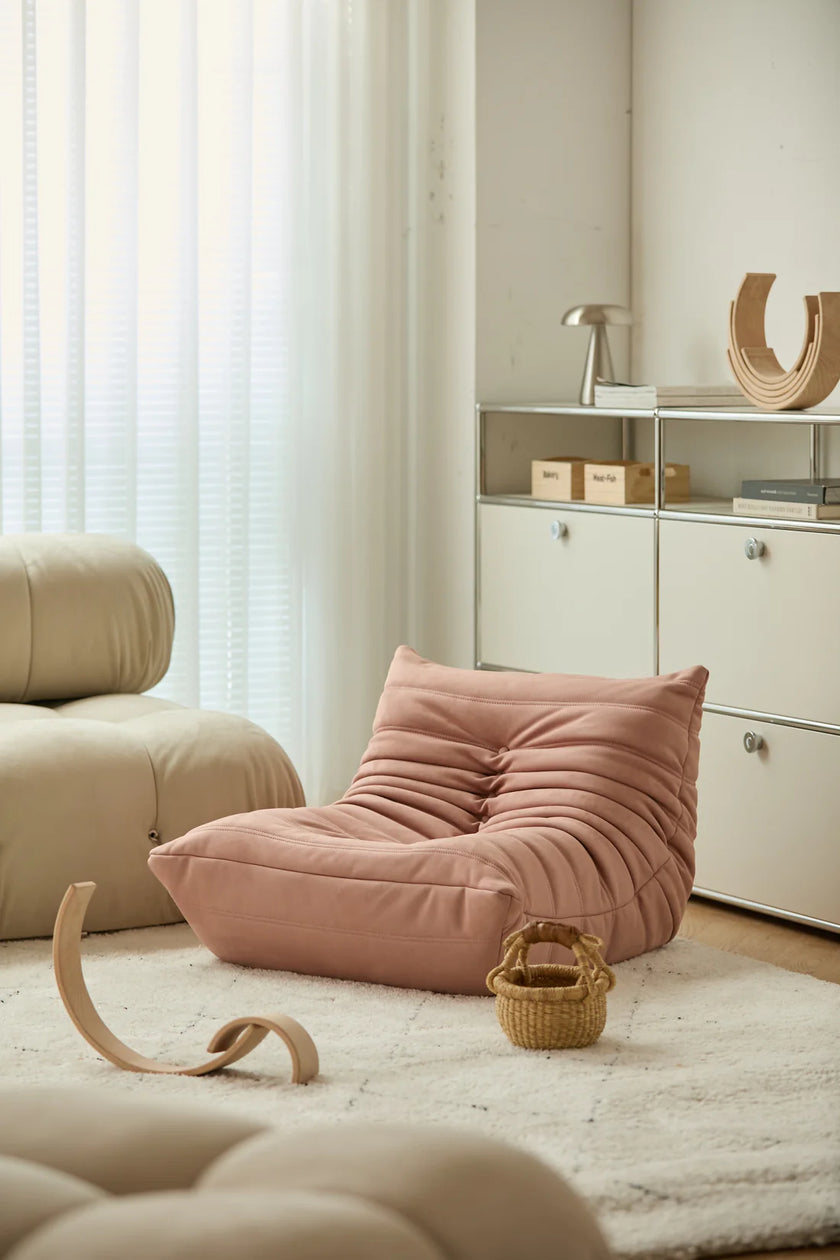Pink kid corduroy sofa in a modern living room with neutral tones