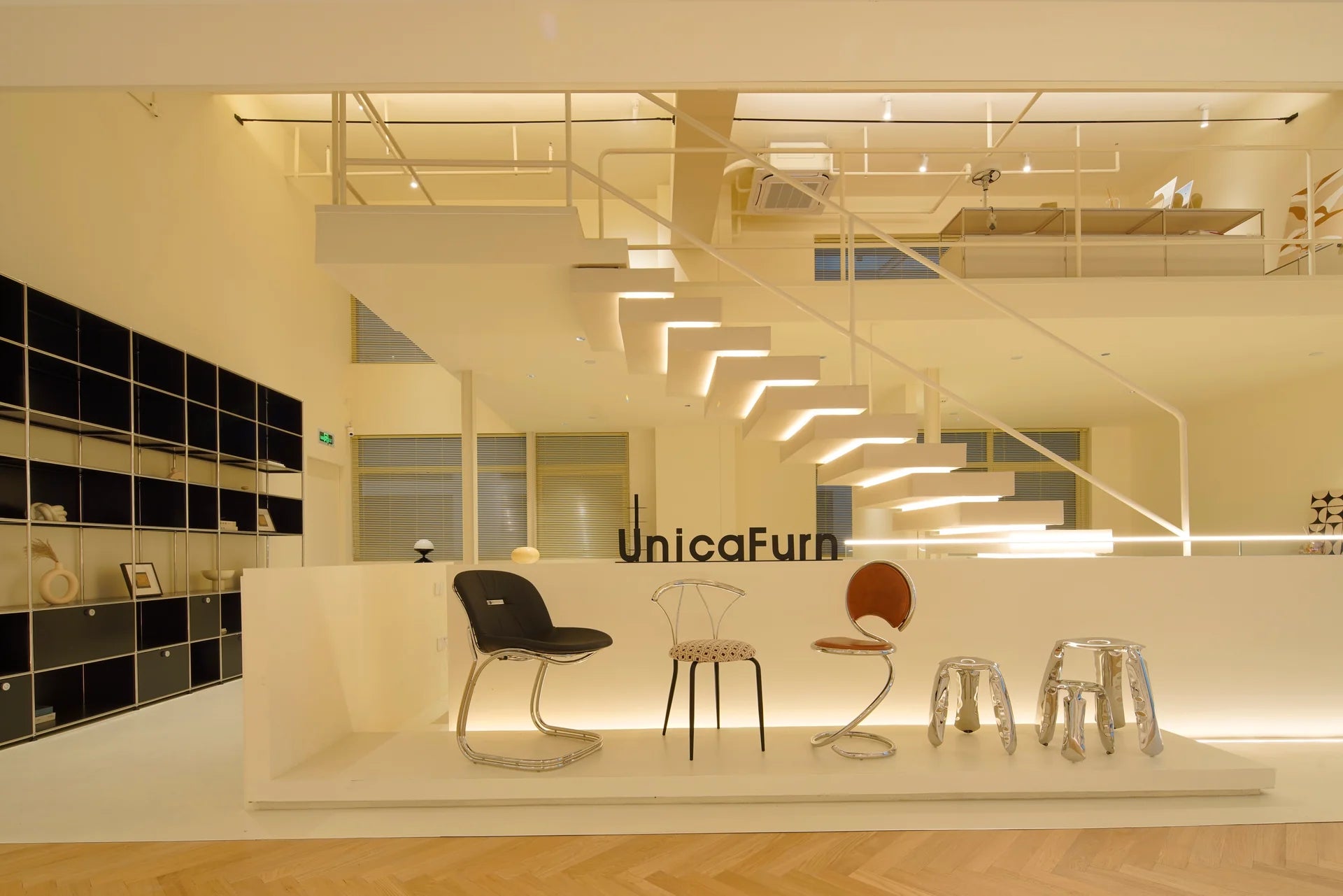 Modern interior design showroom with furniture and 'UnicaFurn' branding.