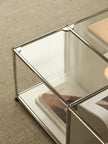 Glass coffee table with metal frame on a beige carpet