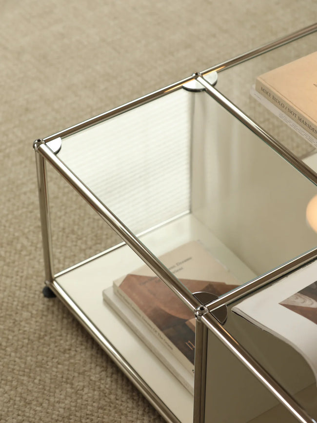 Glass coffee table with metal frame on a beige carpet