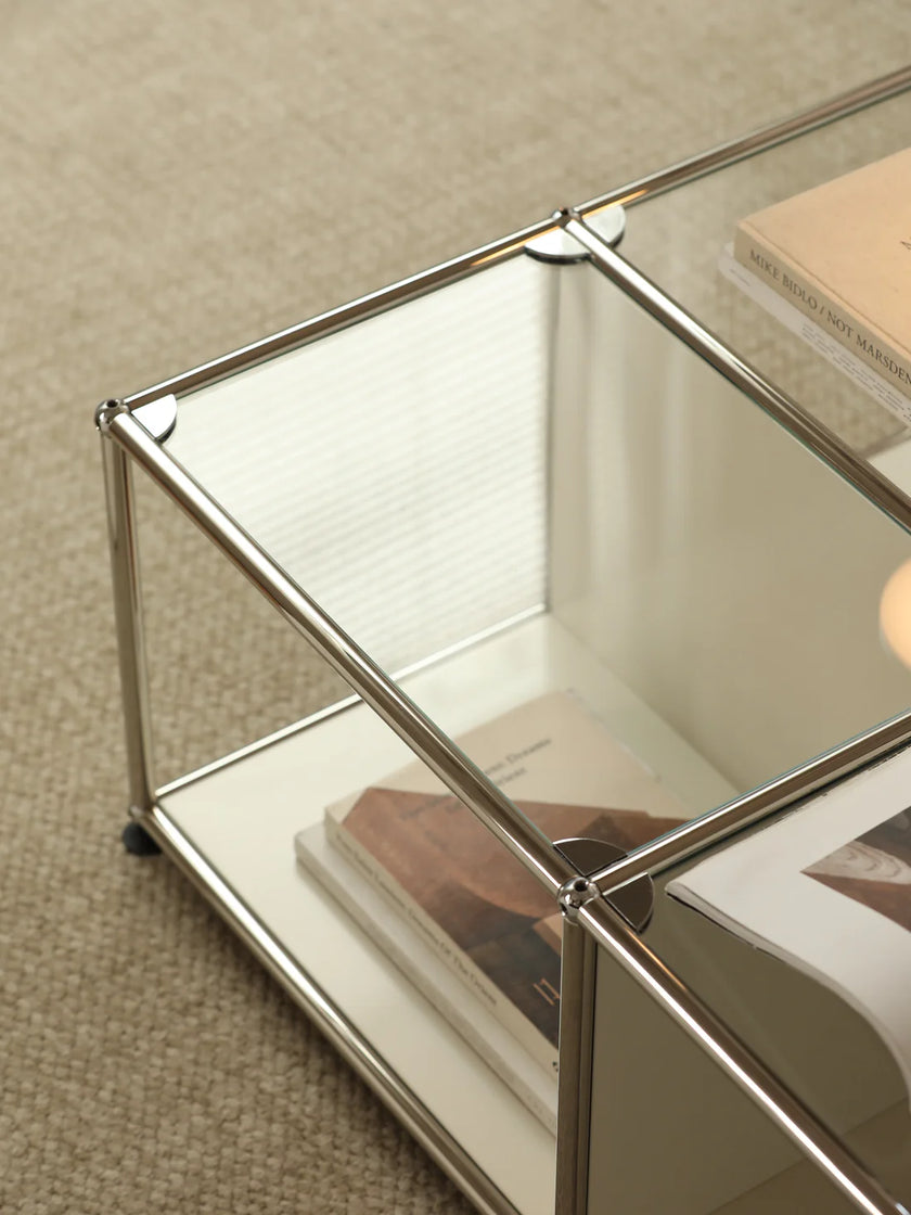 Glass coffee table with metal frame on a beige carpet