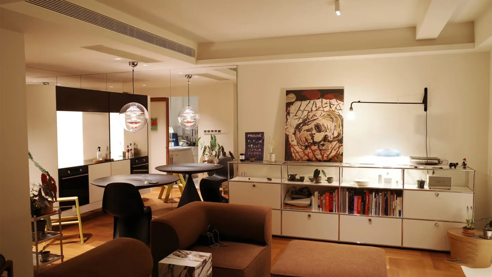 Modern living room with a kitchen in the background