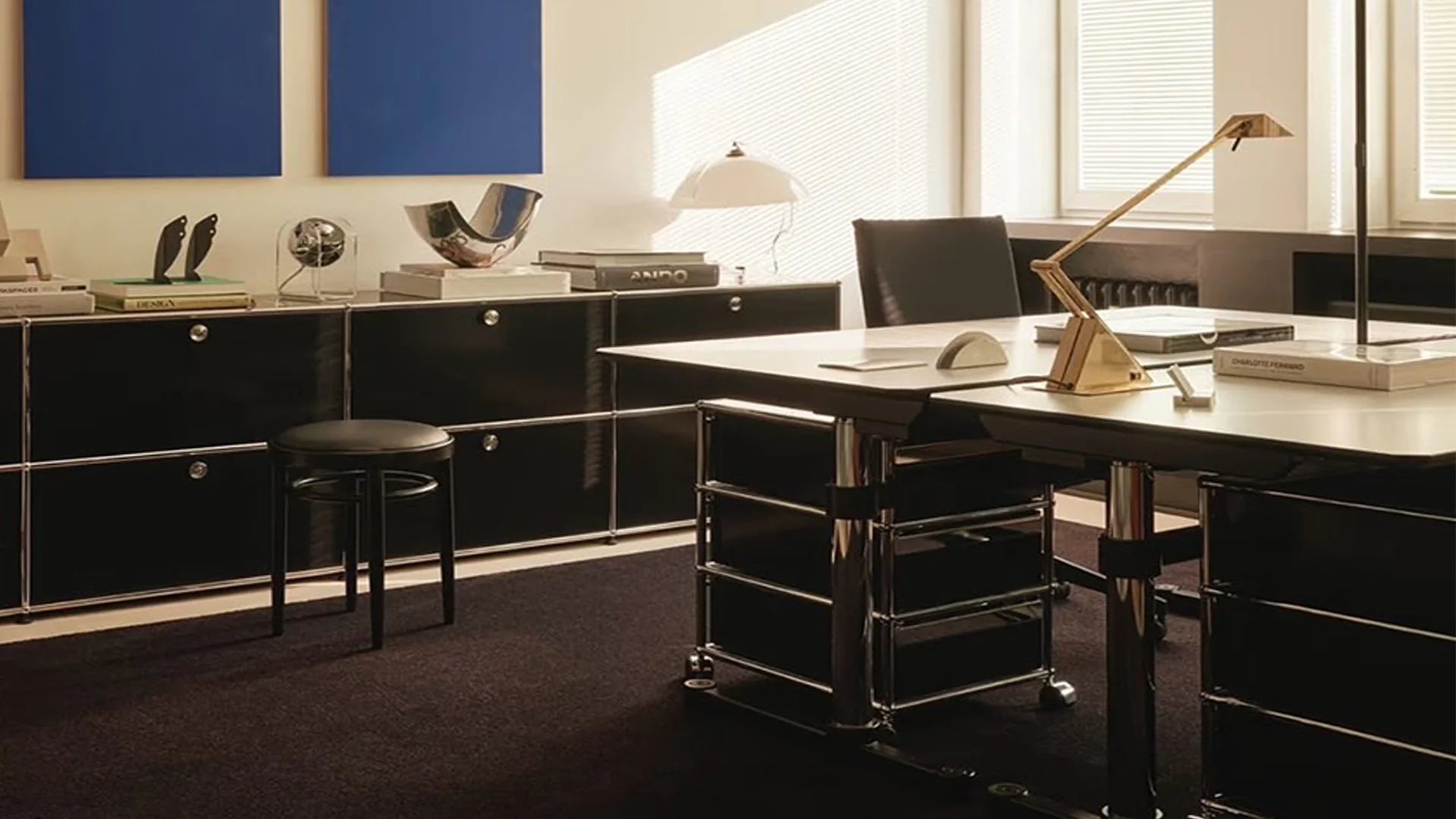 Modern office setup with a desk, chairs, and decorative elements.