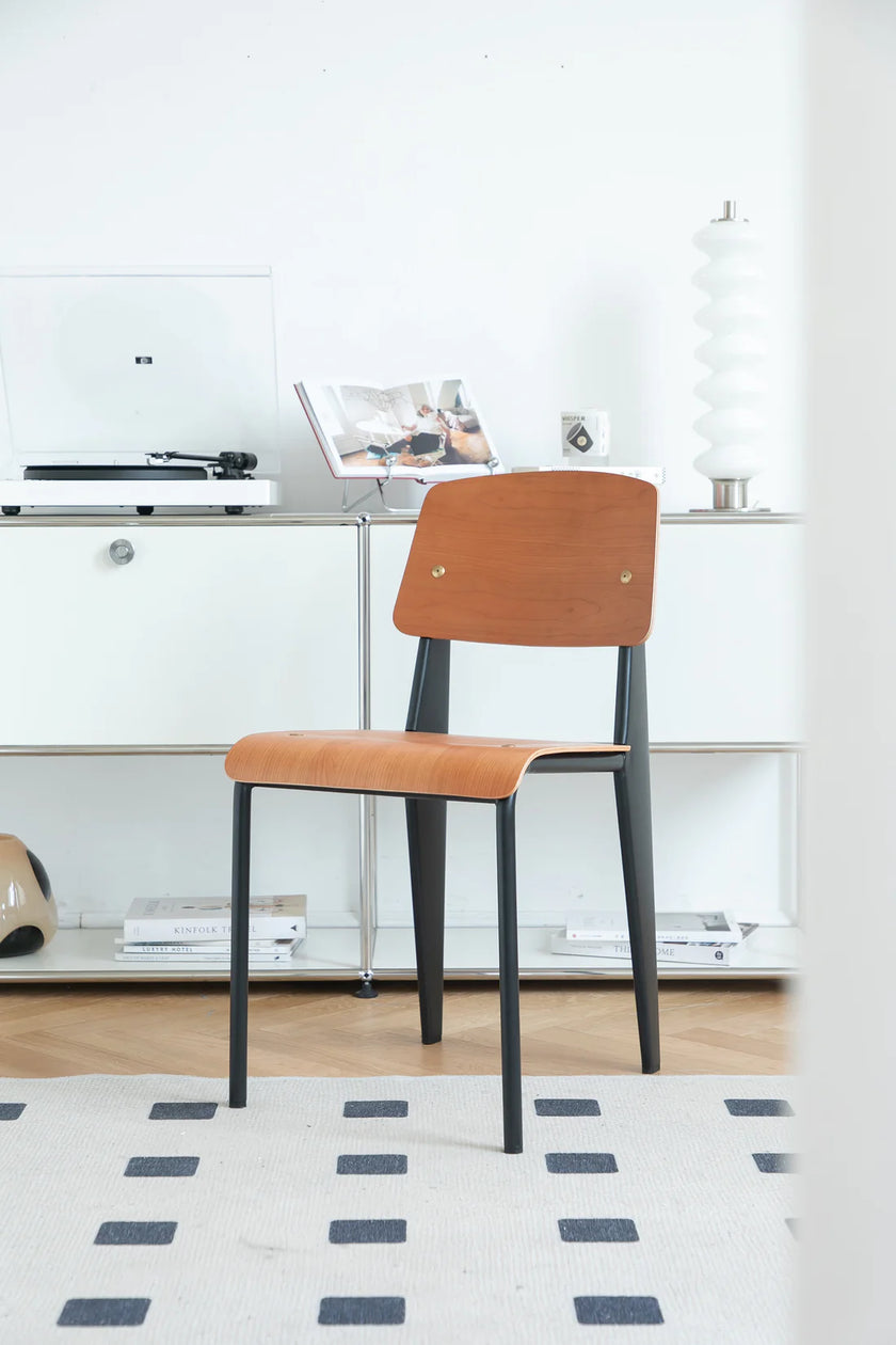 Brown dining room chair in a modern office setting with a desk and decor.