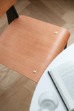Wooden chair with a book and water bottle on a wooden floor