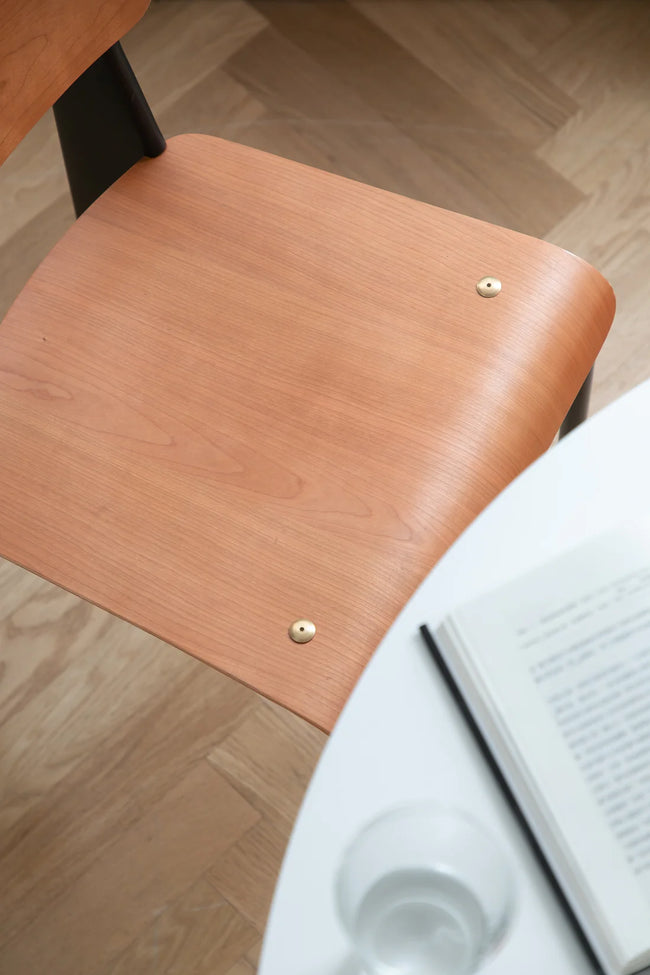 Wooden chair with a book and water bottle on a wooden floor