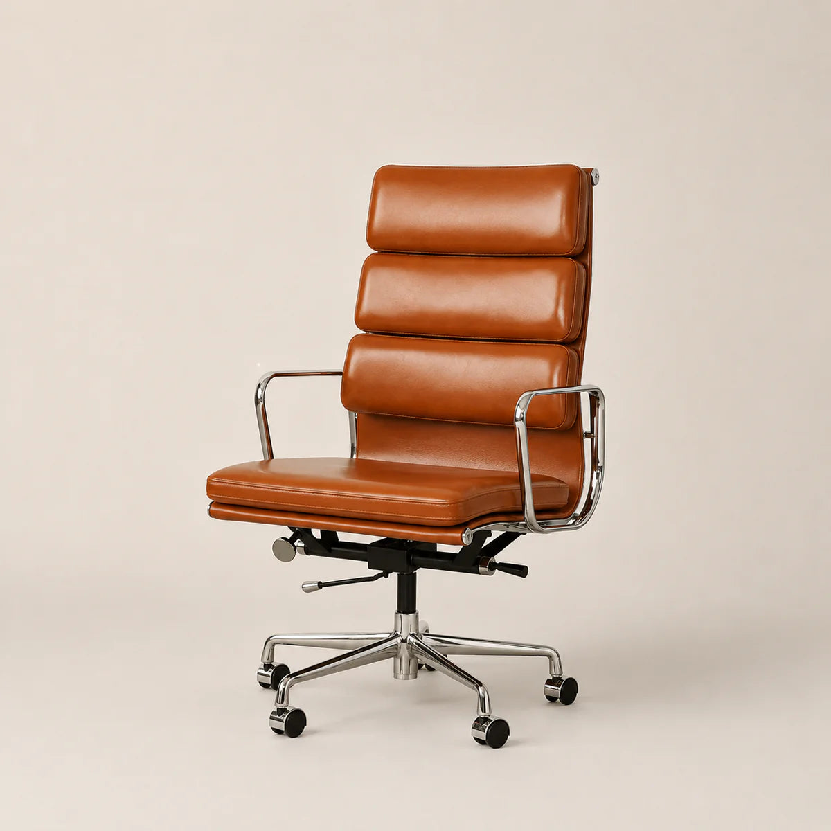 A mid-century modern office chair with a tall segmented backrest, upholstered in warm cognac brown leather, featuring chrome metal armrests and a five-star wheeled base on a light beige background.