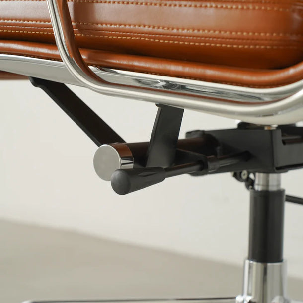 Close-up of a brown leather office chair with metal frame on a white background