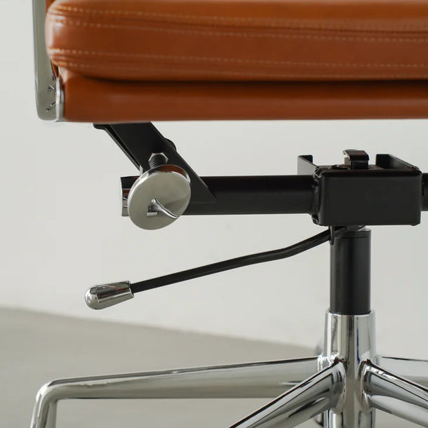 Brown office chair with chrome base on a light gray background
