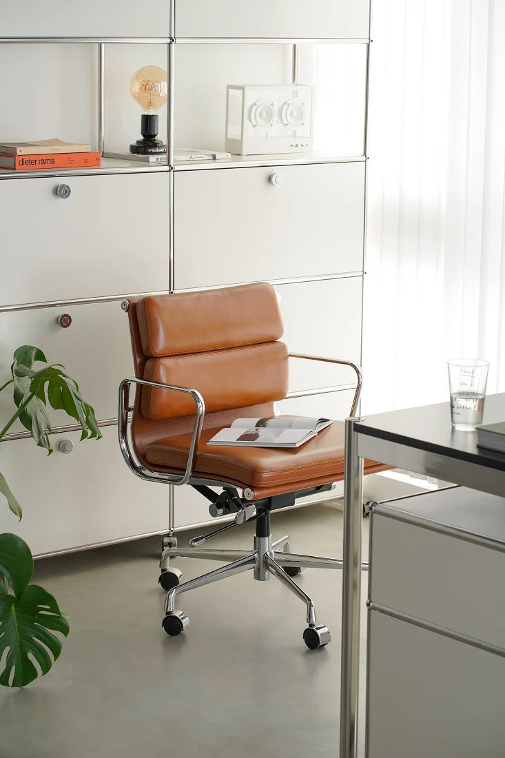 Brown office chair in a modern office setting with white cabinets and a desk.