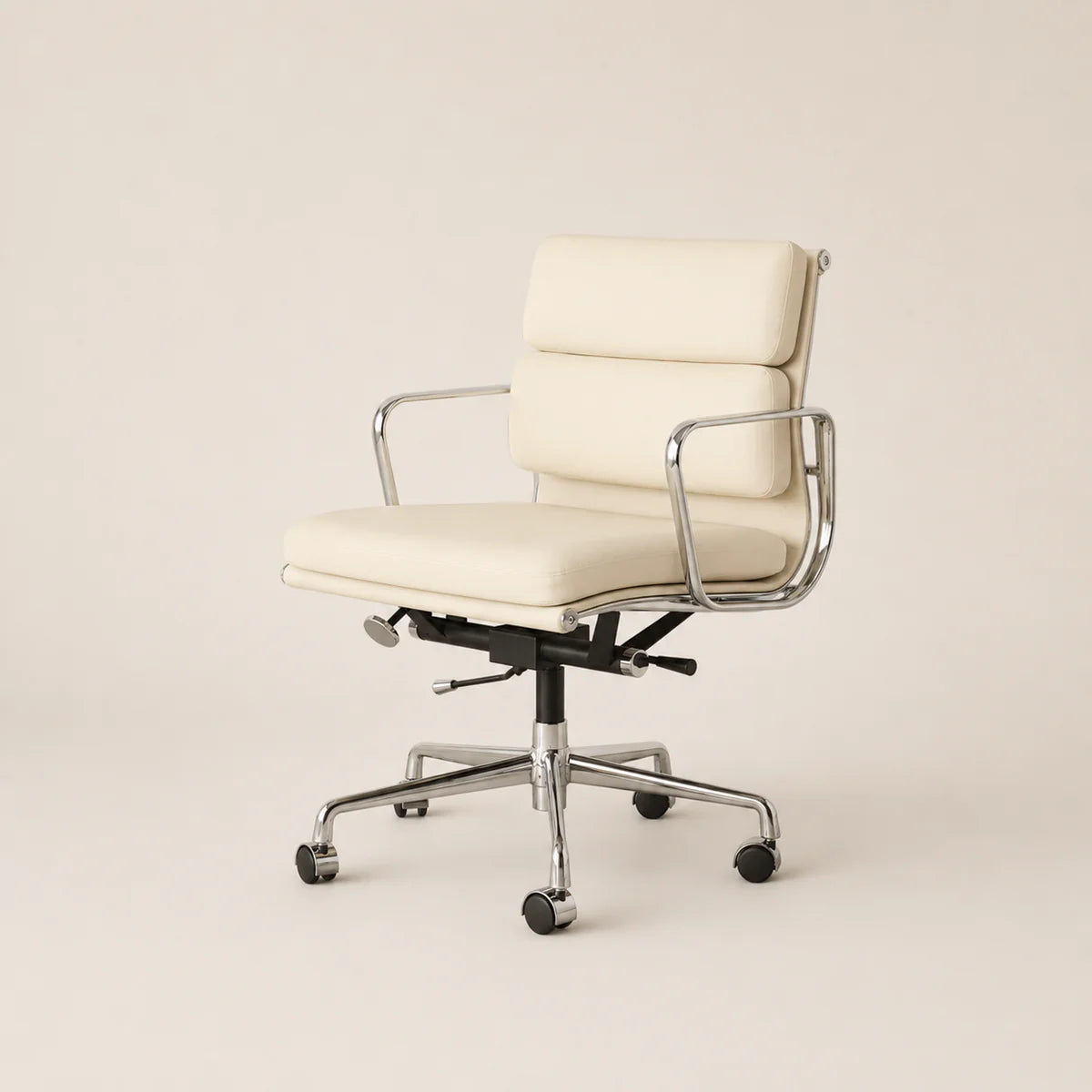 An off-white leather office chair with a chrome metal frame and five-star wheeled base, photographed against a solid light beige background.