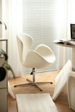 Modern office desk chair in a bright room with a window and desk.