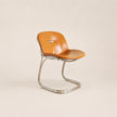 Brown chair with metal frame on a beige background