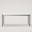 A minimalist rectangular table with a white top and slim metal legs, shown against a neutral light gray background.