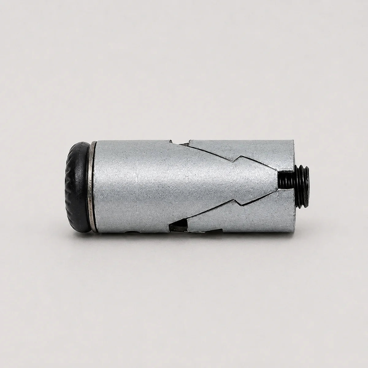 A silver metallic cylindrical device with a textured black end cap and a threaded black port, photographed on a plain light gray background.