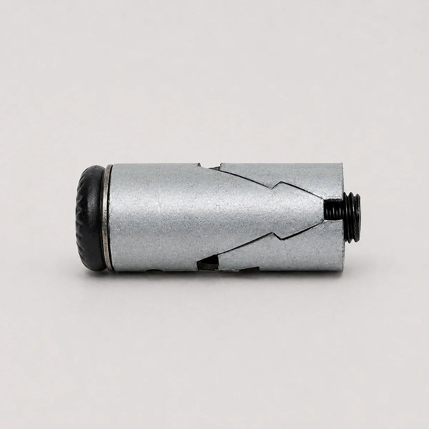 A silver metallic cylindrical device with a textured black end cap and a threaded black port, photographed on a plain light gray background.