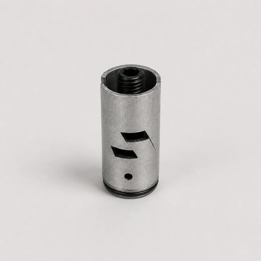 A metallic silver cylindrical component with black threaded openings and cutout details, photographed on a clean light gray background.