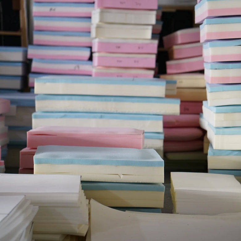 Stacks of colorful foam sheets in various shades.