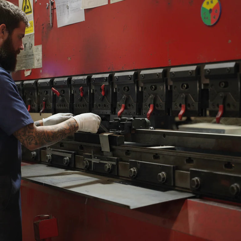 Person operating a large industrial machine in a workshop setting