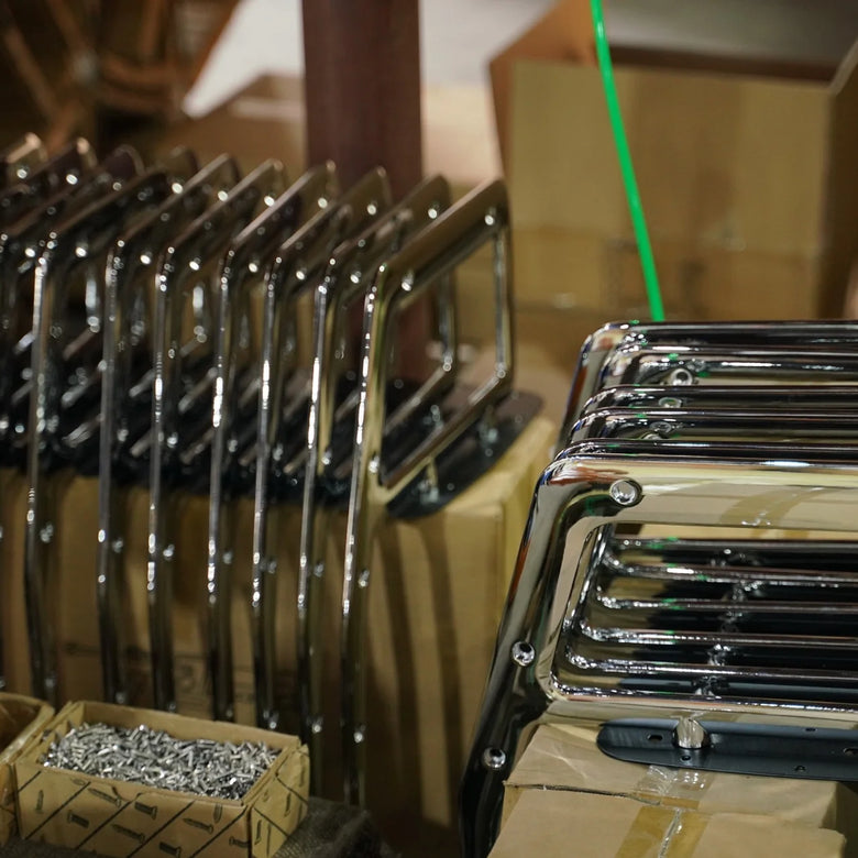 Set of metal tools, likely wrenches, arranged in a row with a blurred background.