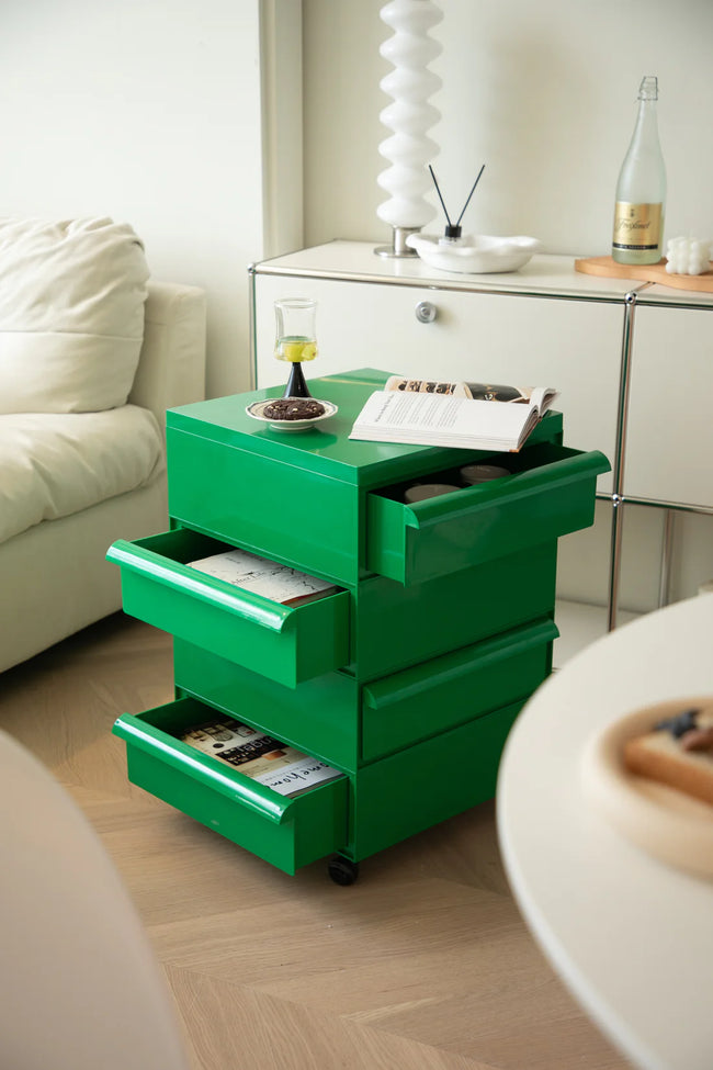 Green storage unit with drawers in a living room setting