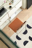 White desk with a brown office chair in a room with a patterned rug