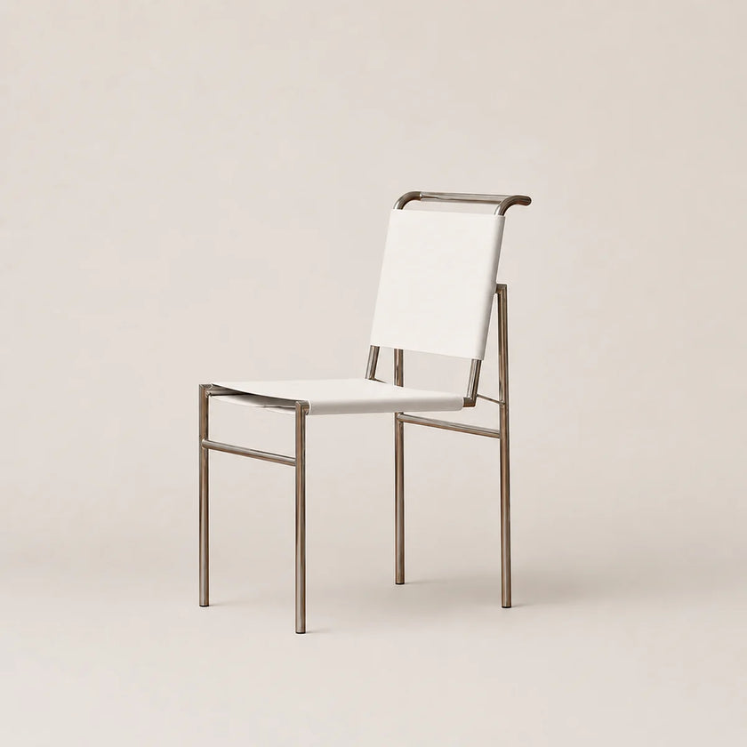A modern dining chair with a white sling fabric seat and backrest, supported by a slim brushed metal frame, shown against a solid light beige background.