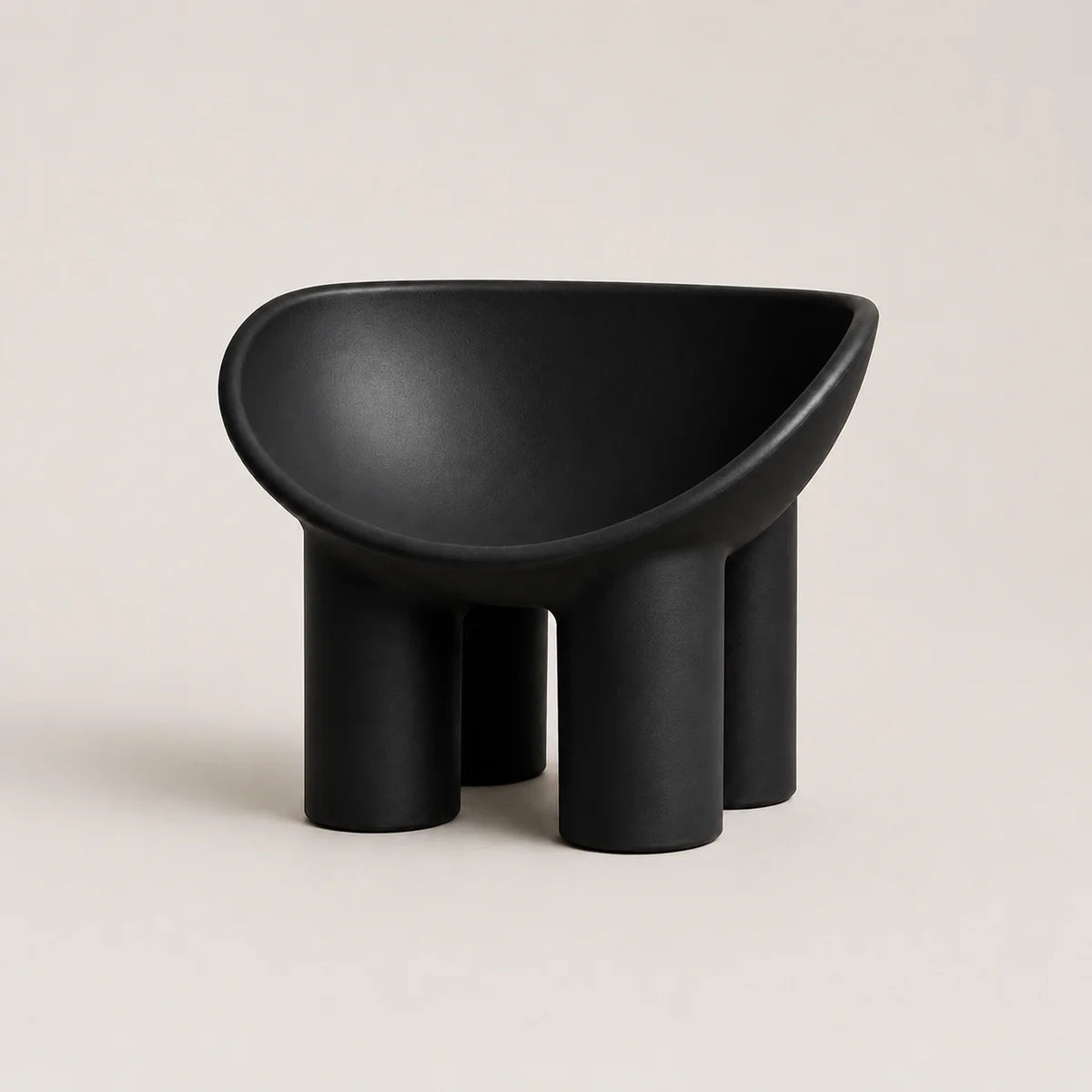 A minimalist black molded PE plastic stool with a wide, rounded seat and four cylindrical legs, shown against a solid light beige background.