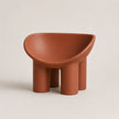 A terracotta-colored molded PE plastic stool with a wide, rounded seat and four cylindrical legs, shown against a plain light beige background.